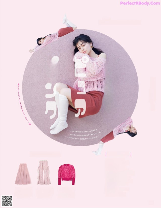 A woman in a pink sweater and skirt laying on the ground.